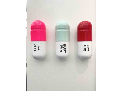 Combination of 30 MG Happy Love pill - Red, mind green and pink over white